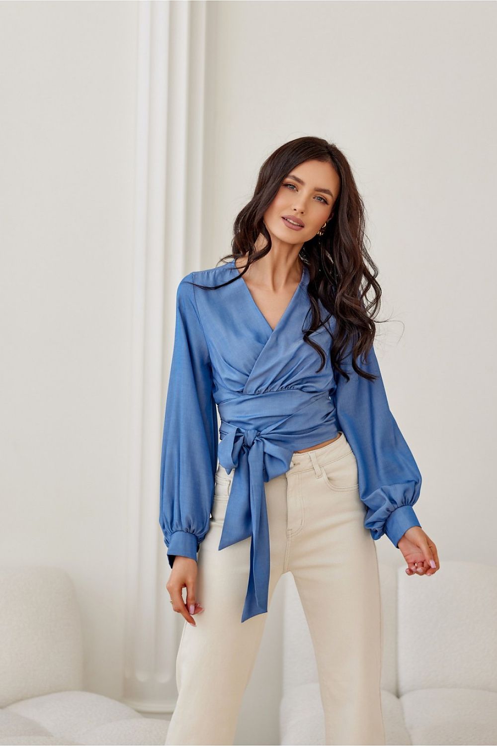 Elegant wrap neckline blouse by Roco Fashion featuring a tie waist and long puffy sleeves, available in sizes EU 36-40 | US 4-8, crafted from premium polyester and viscose blend.