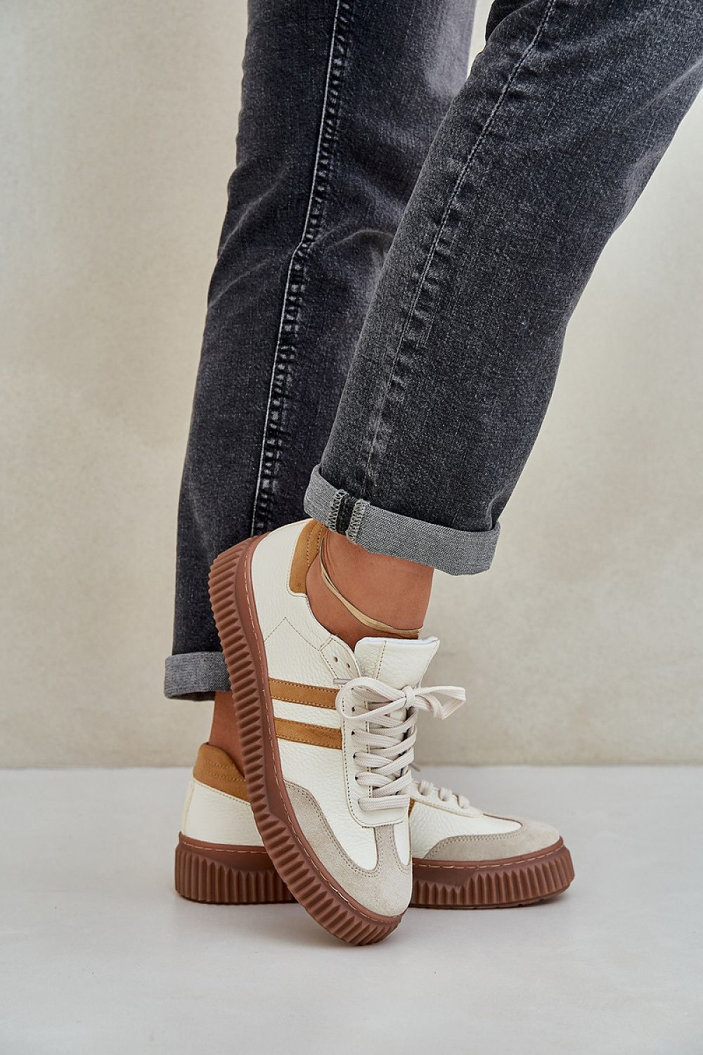 Close-up view of Step in Style luxury women's natural leather sneakers showcasing premium leather texture and intricate lace-up detailing.