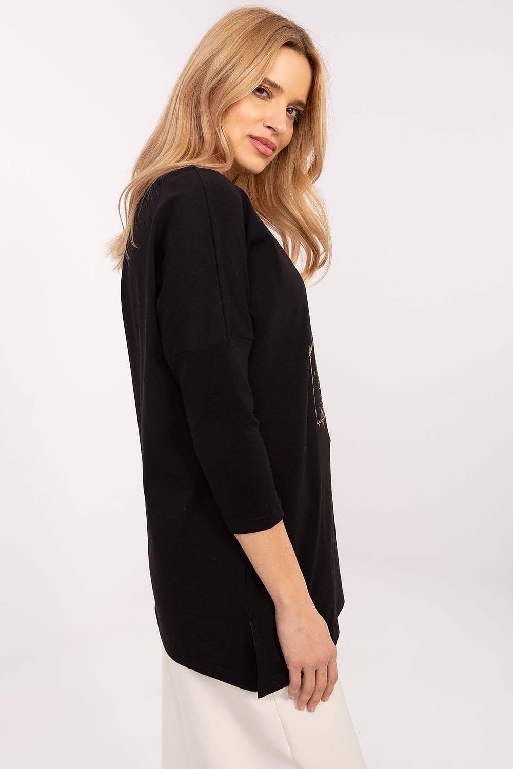 Model wearing the stylish extended cut blouse with 3/4 sleeves by Factory Price, paired with fitted pants for a chic look.