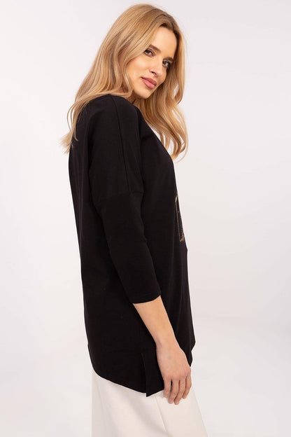 Model wearing the stylish extended cut blouse with 3/4 sleeves by Factory Price, paired with fitted pants for a chic look.