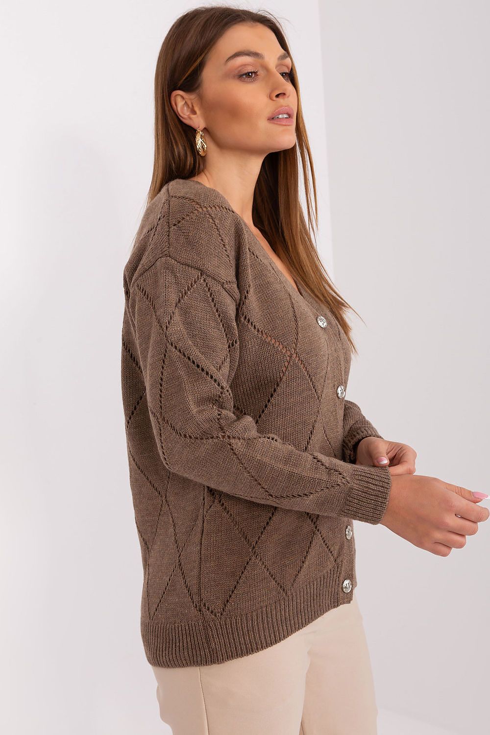 Stylish Rue Paris cardigan displayed in a fashionable pose, highlighting its elegant silhouette, long sleeves, and V-neck, ideal for both casual and chic outfits.