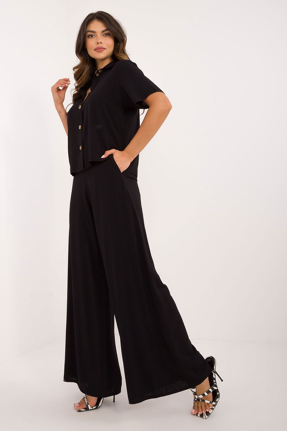 Luxurious Lakerta viscose outfit showcasing a timeless design with wide high waist trousers and a sophisticated button-down shirt.