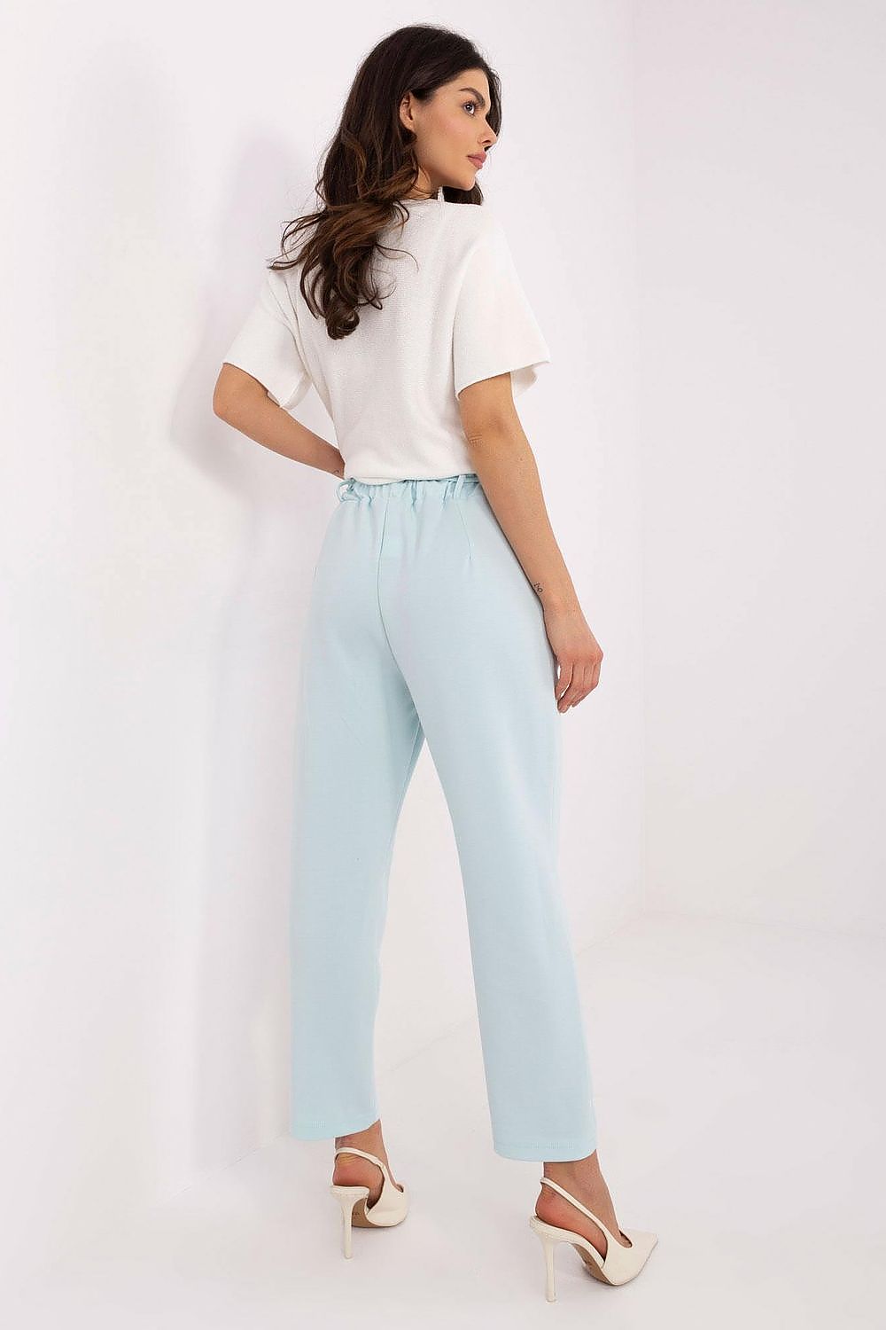 Luxury women's high-waisted tracksuit trousers by Italy Moda, featuring a detachable flower brooch for an elegant touch.