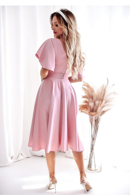 Close-up of the decorative belt on a blue cocktail dress by With You, highlighting the silhouette.