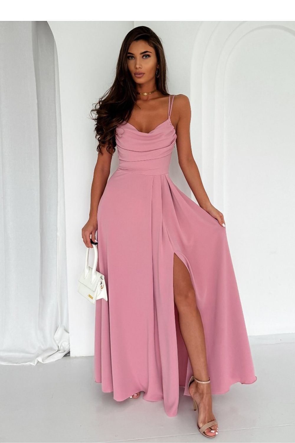 A model elegantly wearing the long dress with a slit, water neckline, and braided tie by With You, catering to sizes EU 32-40, US 0-8.