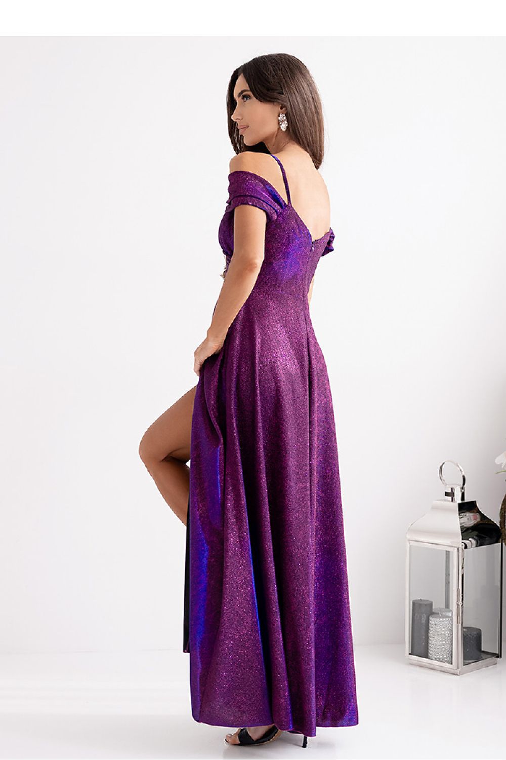 Elegant long dress with wrap neckline and thin straps by With You, featuring a stylish slit and luxurious flowing fabric.