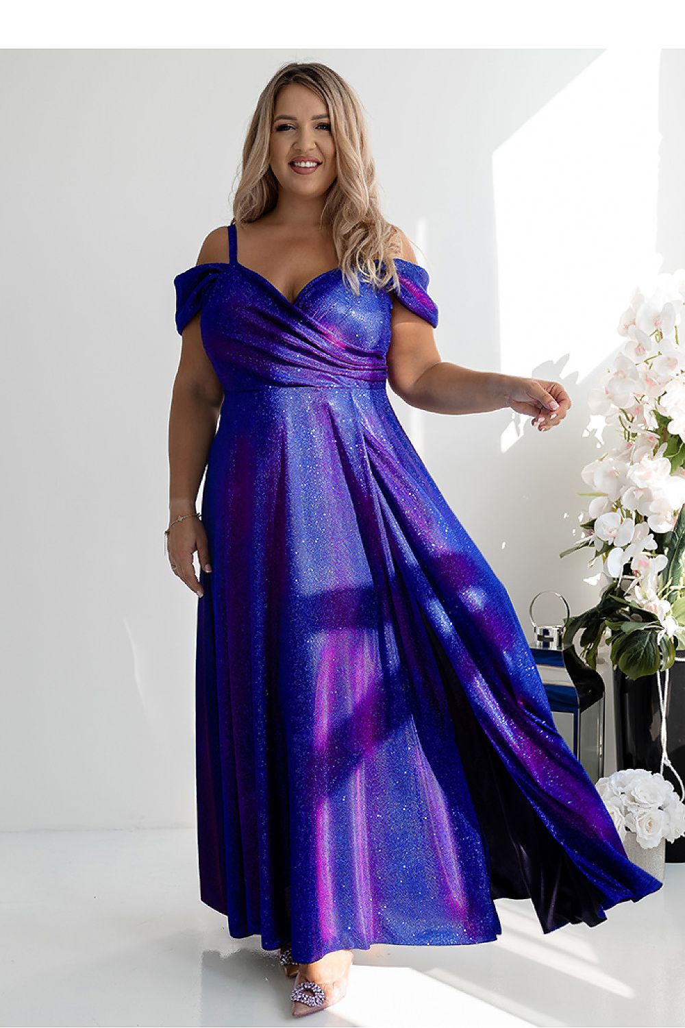 Beautiful long dress by With You, showcasing a stunning slit and flowing silhouette perfect for elegant occasions.
