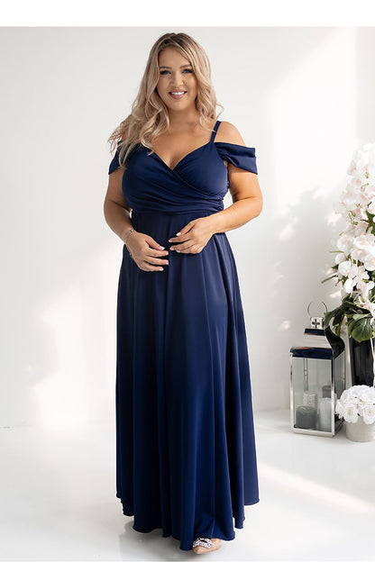 Elegantly styled long flared dress with wrap neckline and thigh-high slit by With You, showcasing luxurious flowing fabric.