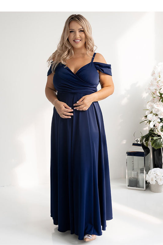 Elegantly styled long flared dress with wrap neckline and thigh-high slit by With You, showcasing luxurious flowing fabric.
