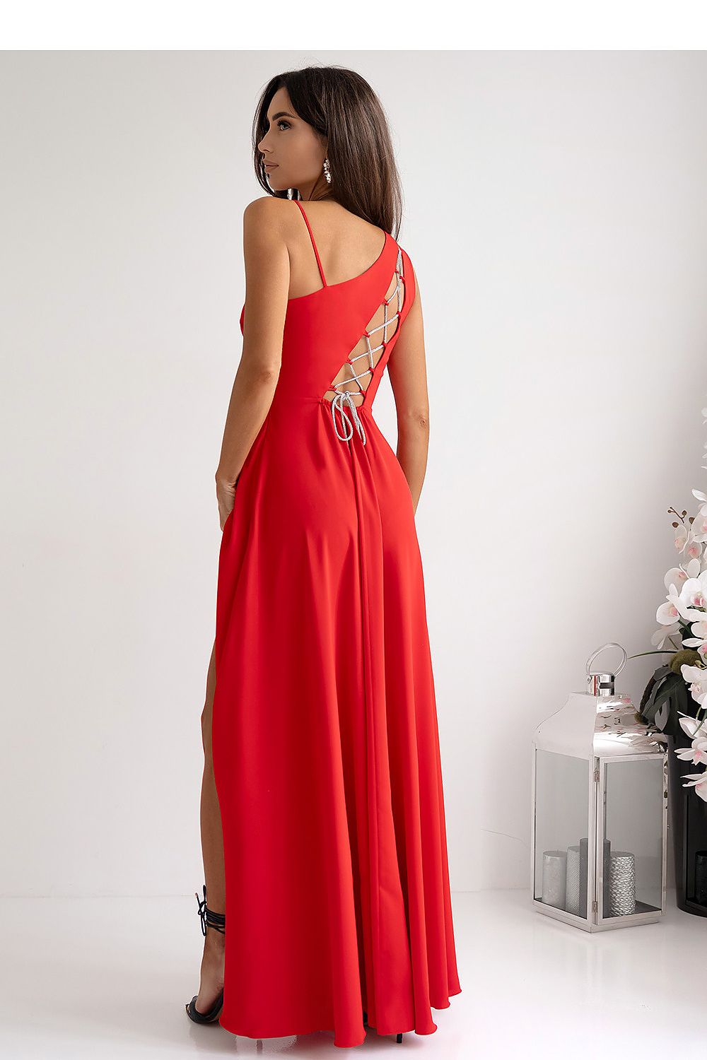 Stylish side view of the long flared dress by With You, highlighting its unique design features and luxurious fabric.