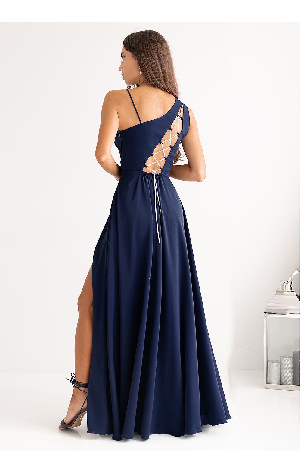 Elegant asymmetrical strap long flared dress with cutout back, designed by With You, showcasing a luxurious silhouette for sizes EU 32 to EU 46.