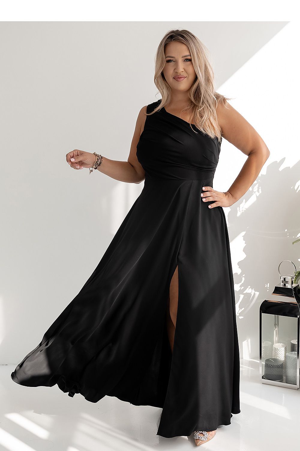 Side view of the long elegant dress with a hidden zipper, designed by With You, highlighting the sophisticated fit and stylish flared bottom.