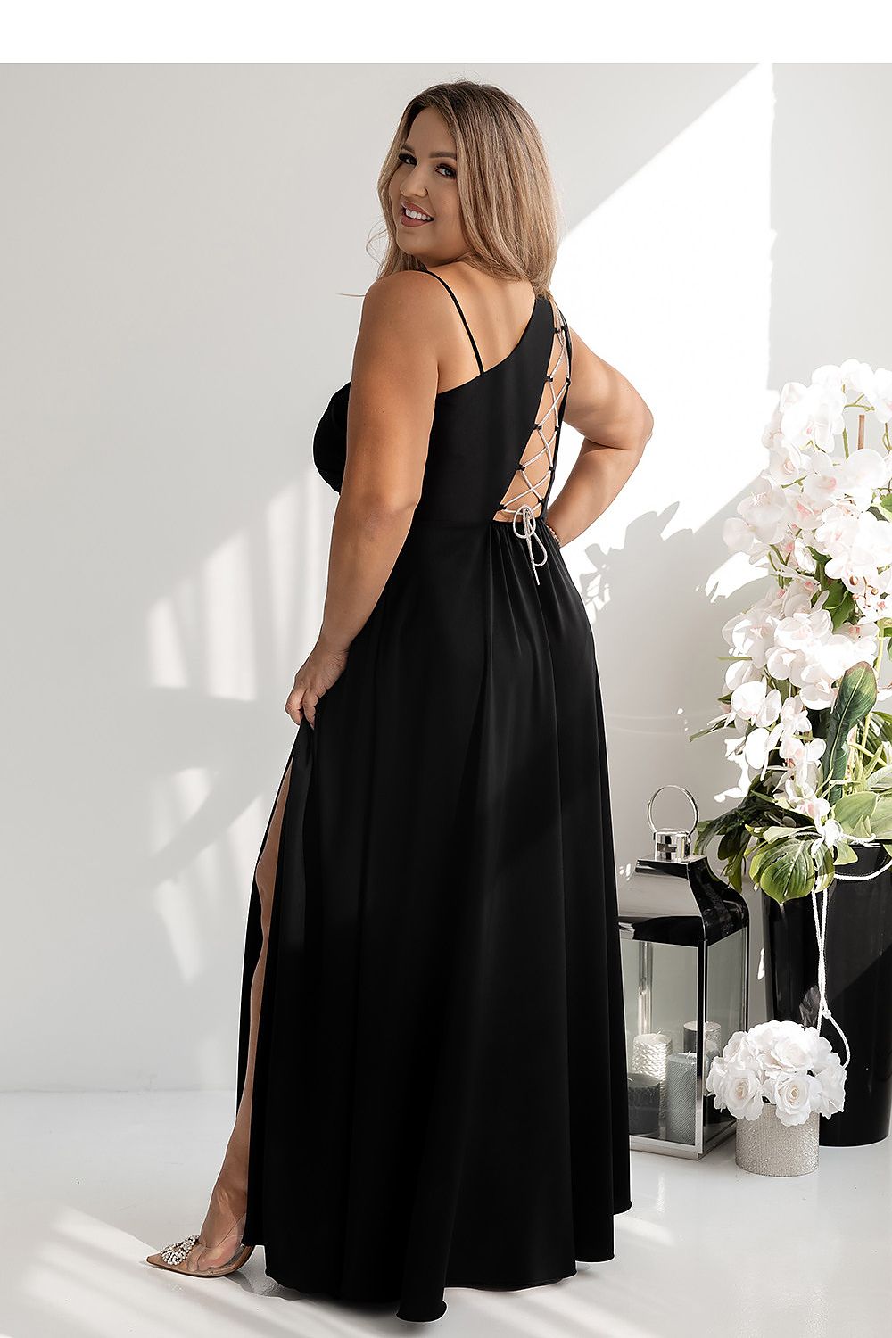 Model wearing the luxurious asymmetrical strap flared dress by With You, demonstrating its stunning design and flattering shape in various sizes.