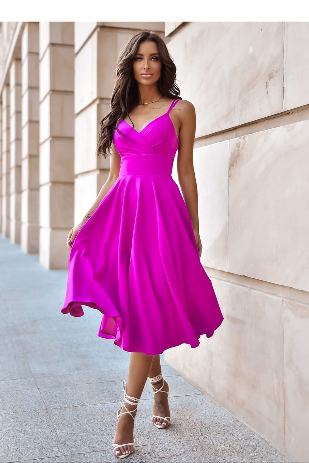 Elegant evening dress by With You, showcasing a deep wrap neckline and flared slit, suitable for formal occasions.