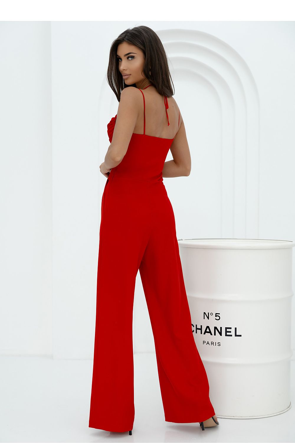 Stylish women's jumpsuit from With You, showcasing a belted waist, feminine silhouette, and chic design with thin straps and pleating.