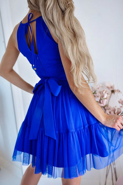 Stylish evening dress by With You, crafted from soft tulle with a flared bottom and decorative tie belt, suitable for elegant events, offered in EU sizes 34 to 40.