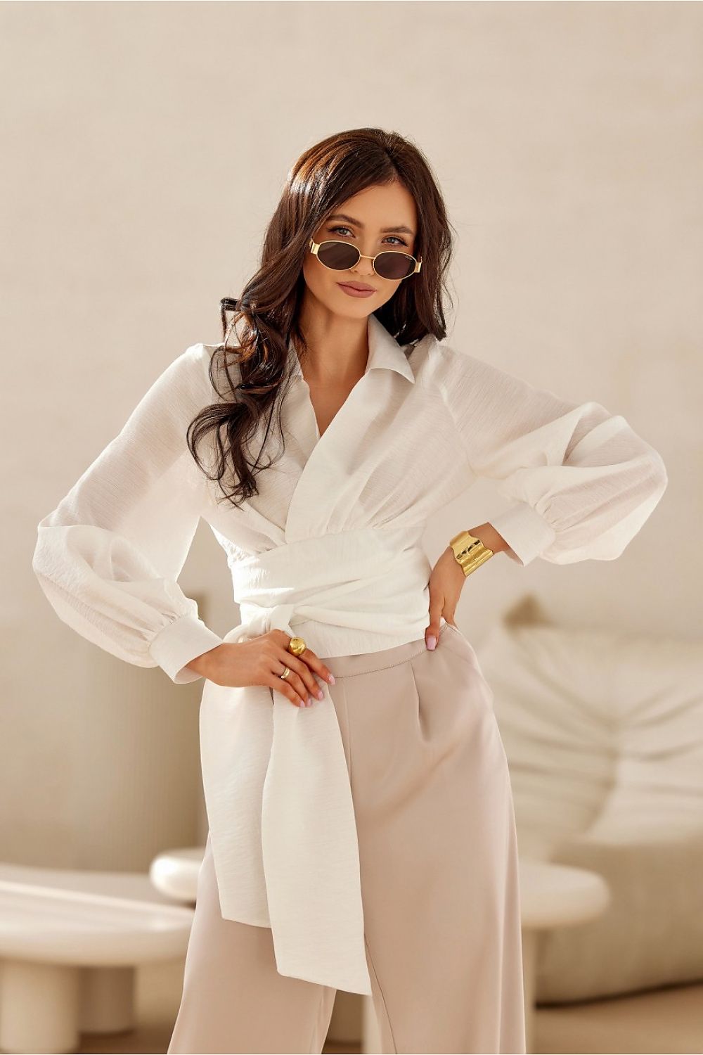 Roco Fashion's stylish cropped blouse in elegant setting, highlighting its tie waist and puff sleeve design suitable for classy outfits.