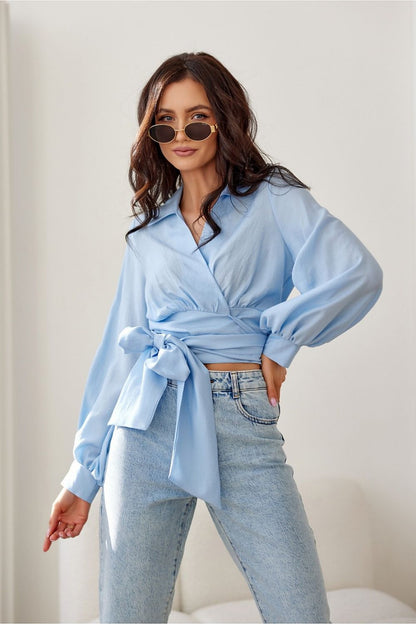 Roco Fashion's luxury blouse on a model, displaying how to style the cropped design with trendy trousers for an upscale look.