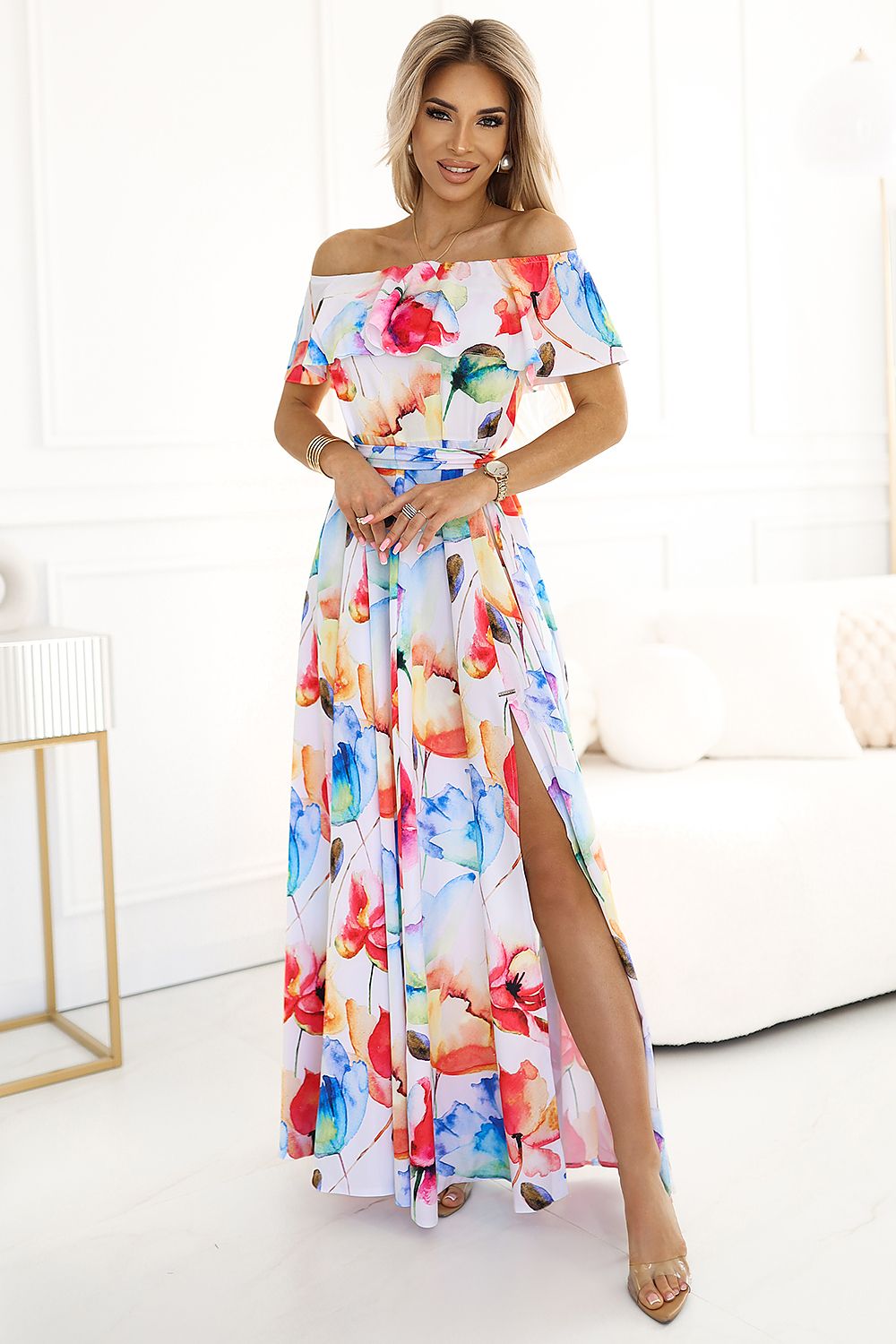 Elegant long Spanish dress with a floral print, designed by Numoco, showcasing vibrant colours and a flattering silhouette, perfect for summer occasions.
