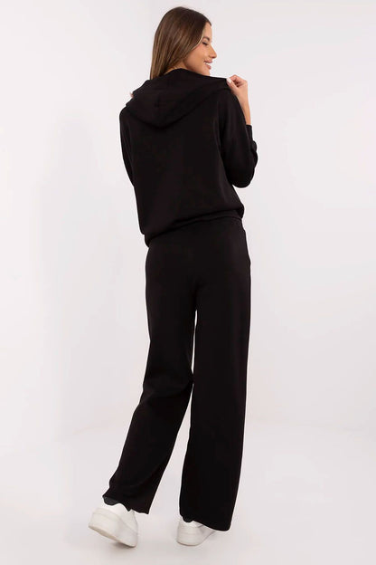 Model showcasing the Italy Moda luxury women's tracksuit set, highlighting the practical hood, zippered hoodie, and adjustable high-waisted pants for ultimate comfort.