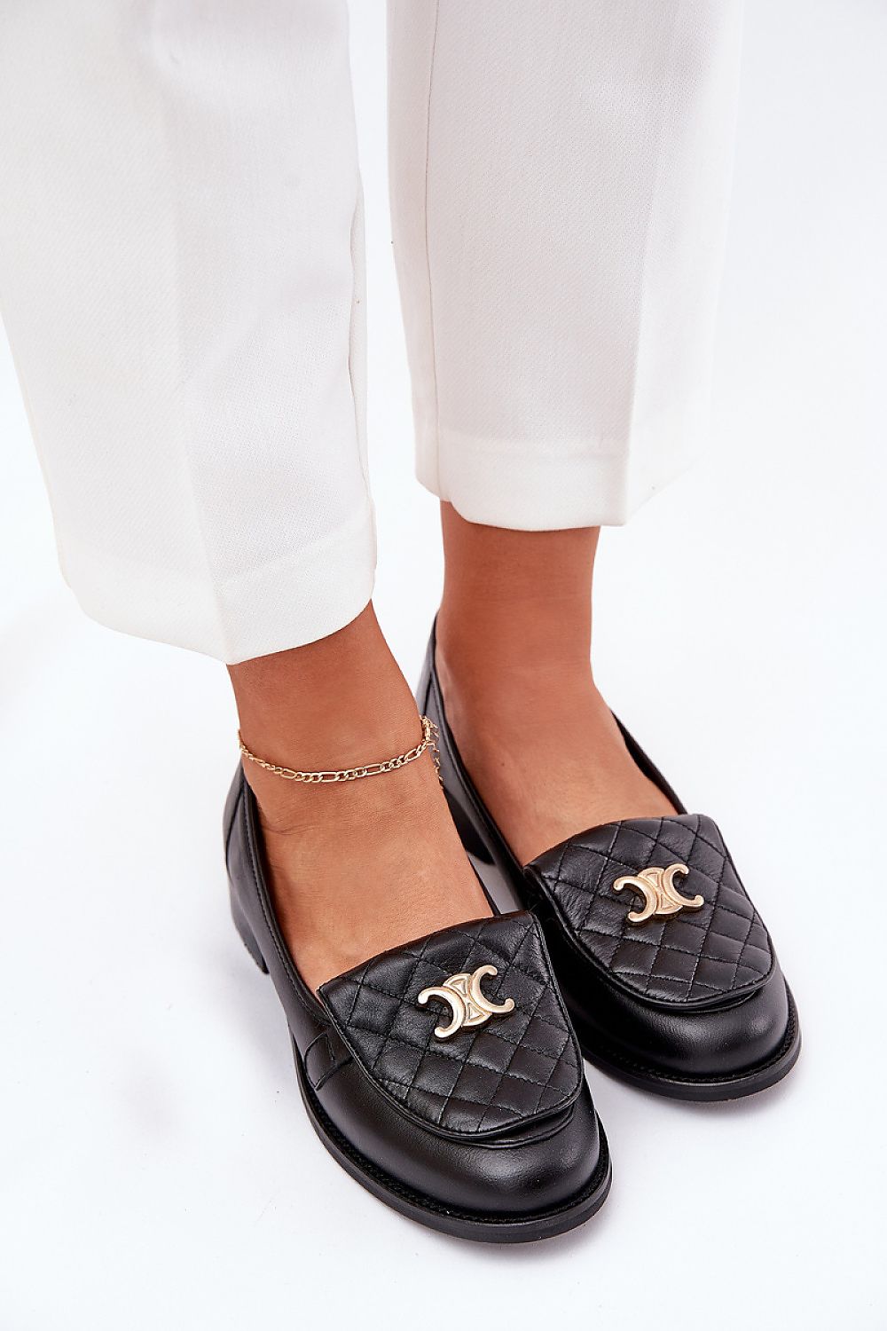 Stylish view of Step in Style's elegant women's moccasins made from high-quality natural leather, showcasing intricate stitching and luxurious gold accents.