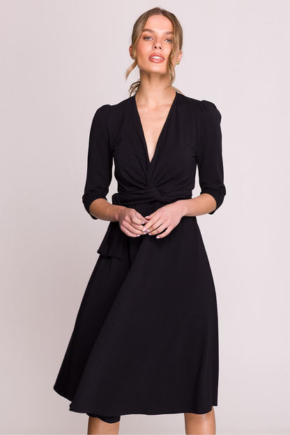 Model wearing the Stylove Elegant V-Neck Modal Daydress with a flattering silhouette, emphasising the waist tie and knee-length skirt for a sophisticated look.