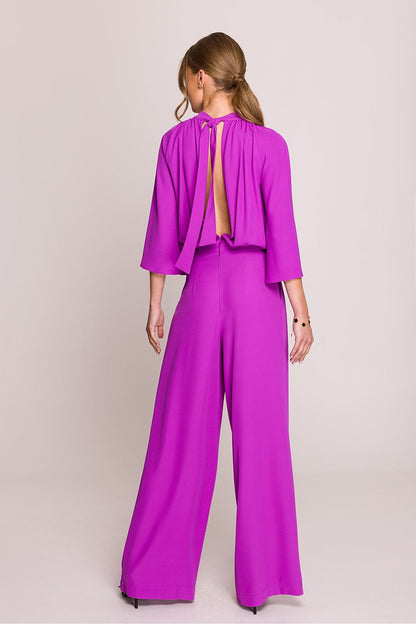Stylove elegant jumpsuit with side pockets, beautifully draped trousers and stand-up collar, designed for elegance and comfort in any setting.