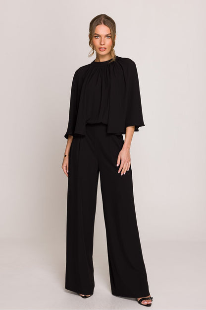 Stylove refined jumpsuit model with intricate detailing at the back, capturing the essence of luxury fashion for special occasions.