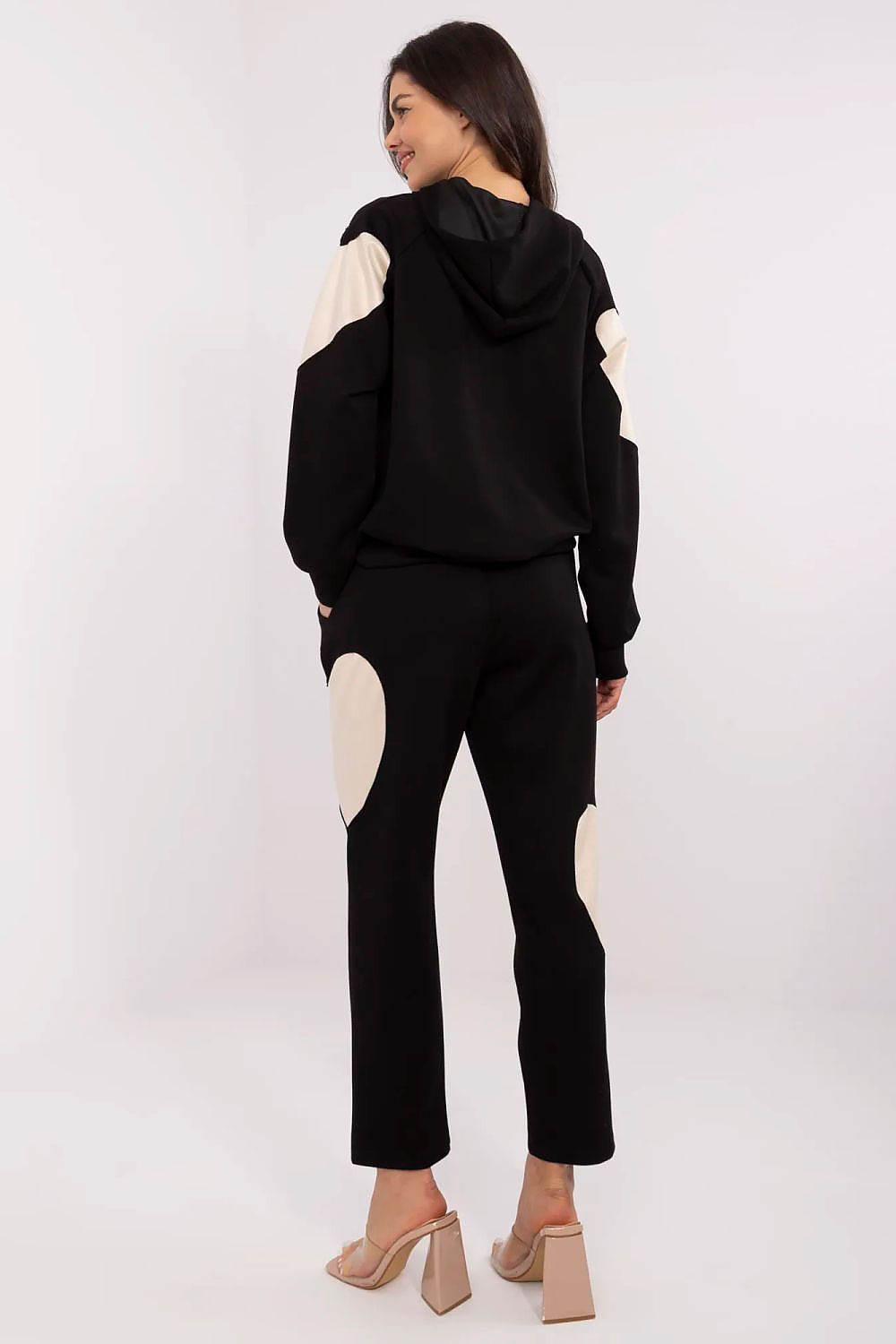 Elegant Italy Moda tracksuit set showcasing the comfortable hoodie and flattering high-waisted pants, designed for a chic, minimalist look.