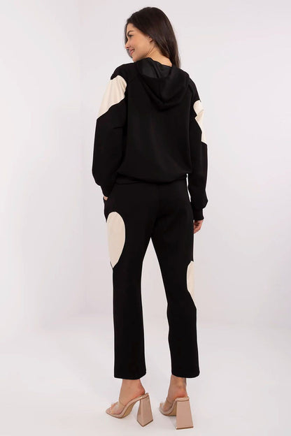 Elegant Italy Moda tracksuit set showcasing the comfortable hoodie and flattering high-waisted pants, designed for a chic, minimalist look.