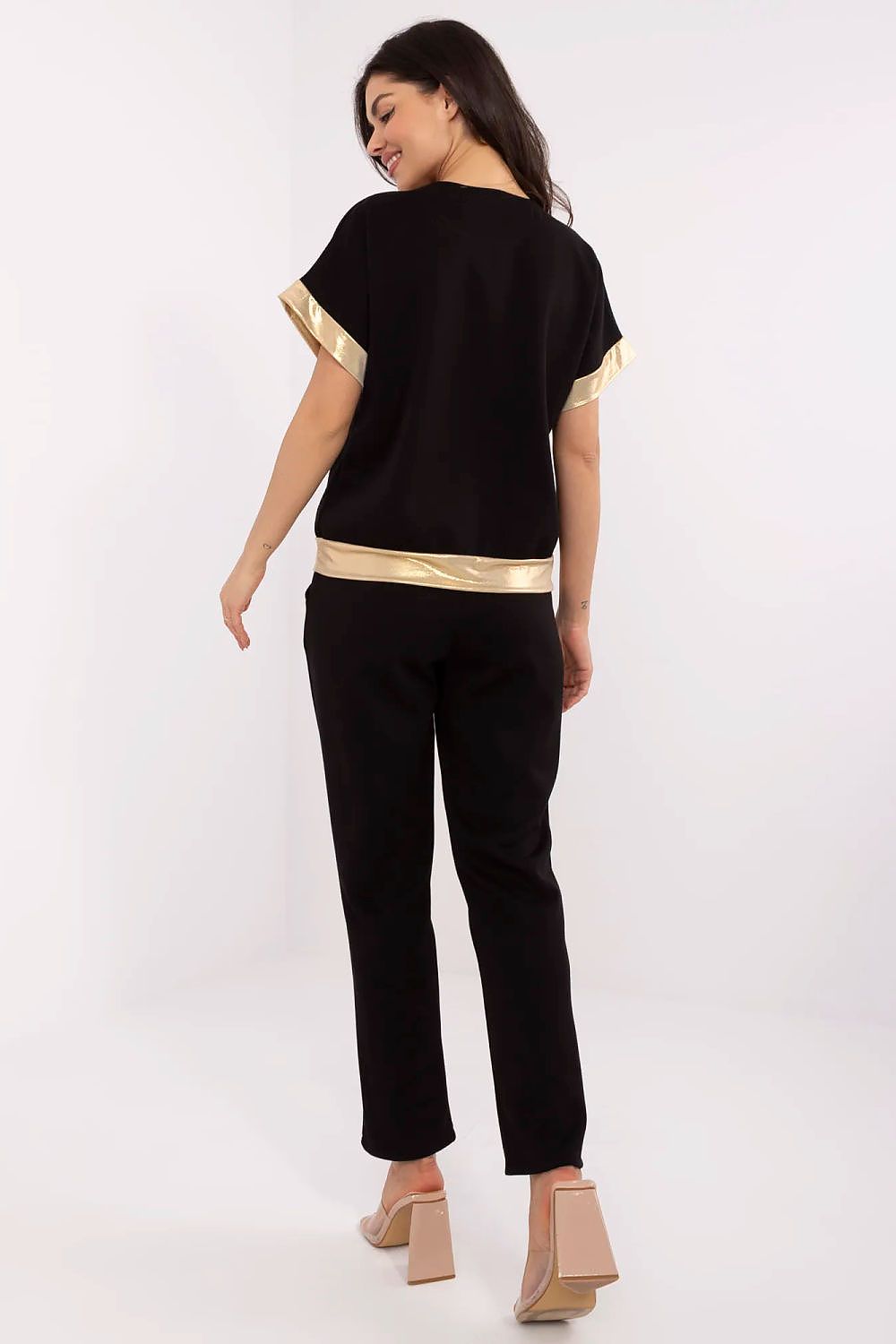 Model wearing an elegant Italy Moda women's set with V-neck blouse and high-waisted trousers, perfect for everyday casual or formal occasions.