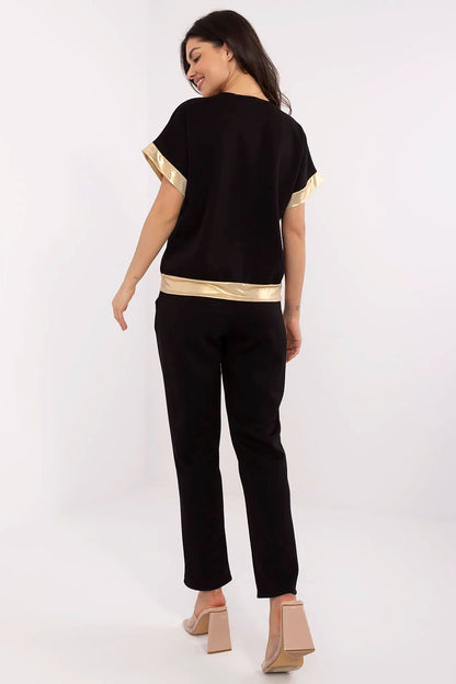 Model wearing an elegant Italy Moda women's set with V-neck blouse and high-waisted trousers, perfect for everyday casual or formal occasions.