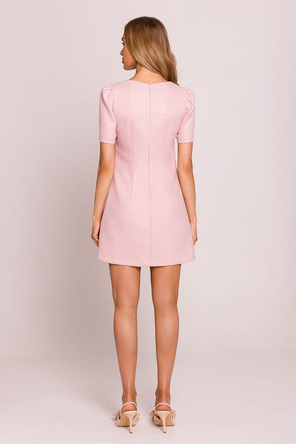 Elegant trapeze mini dress designed by Moe featuring charming heart-shaped gold buttons on the front, perfect for a romantic and sophisticated look, displayed on a model against a soft background.