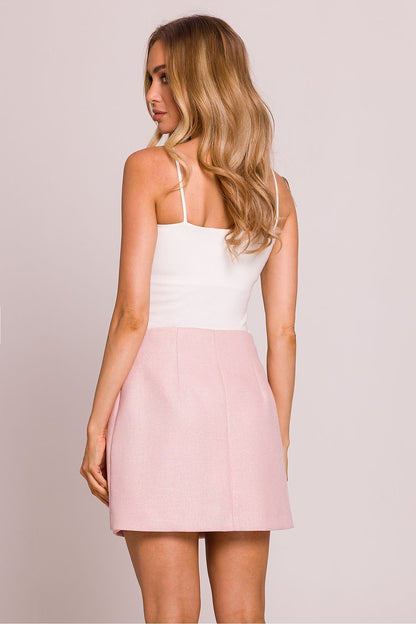 The elegant Moe mini skirt displayed on a model, highlighting the trapeze cut and sophisticated design for a fashionable look.