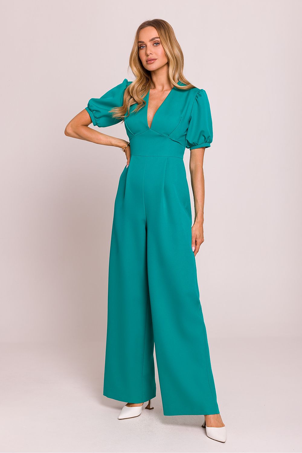 Elegant Moe Women's jumpsuit featuring a deep V-neck and flared trousers, beautifully showcasing feminine sophistication.