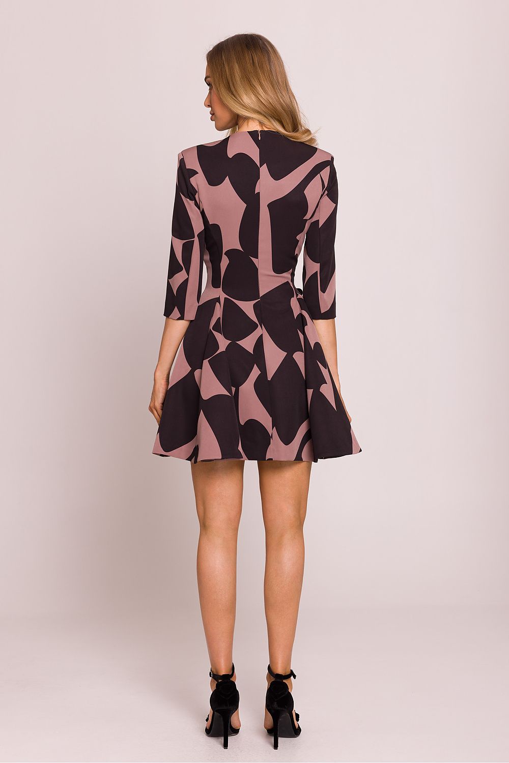 Flared bottom of Moe's enchanting V-neck mini dress, highlighting lightweight fabric and sophisticated design.