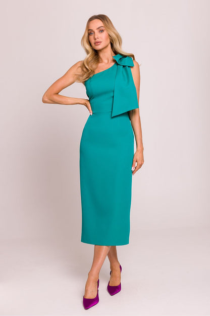 Stunning elegant asymmetrical cocktail dress by Moe featuring a high slit and fancy bow detail, designed to accentuate the feminine silhouette.