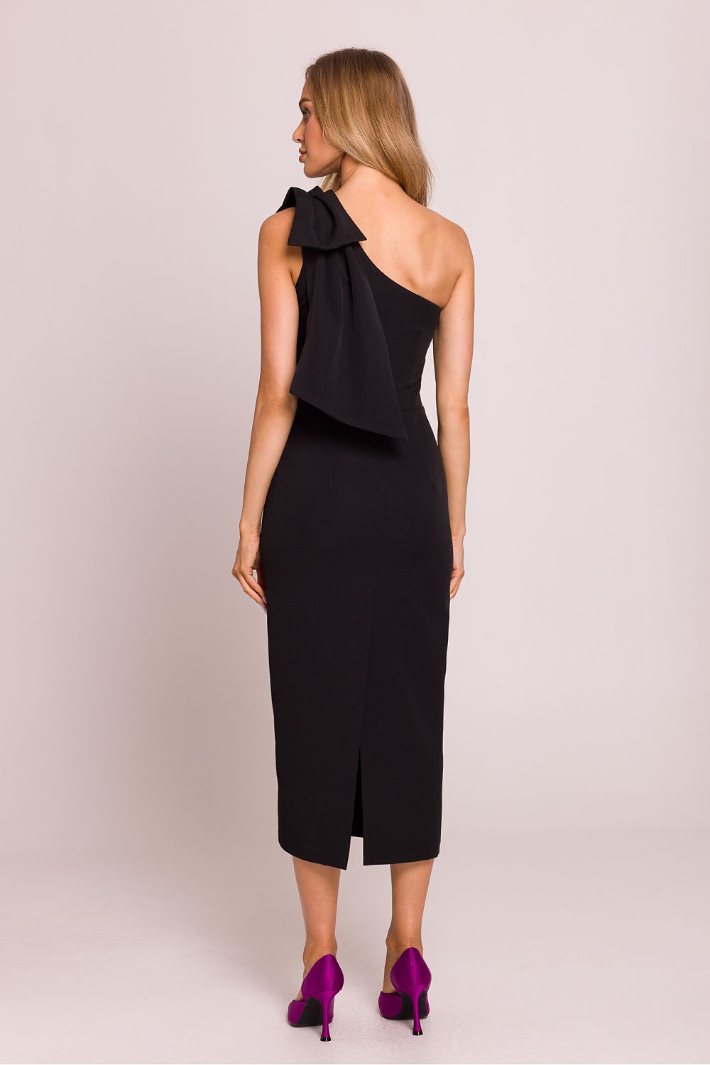 Stylish flat lay presentation of Moe's asymmetrical cocktail dress, showcasing its luxurious fabric and exquisite craftsmanship ideal for elegant celebrations.