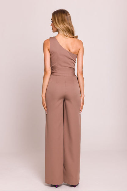 Close-up of Moe's elegant asymmetrical jumpsuit showcasing exquisite Polish craftsmanship and luxurious materials.