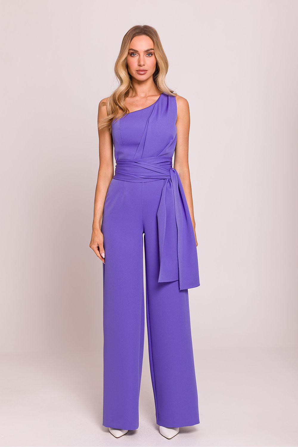 Elegant asymmetrical jumpsuit by Moe displayed on a hanger, illustrating its unique design and luxurious appeal.