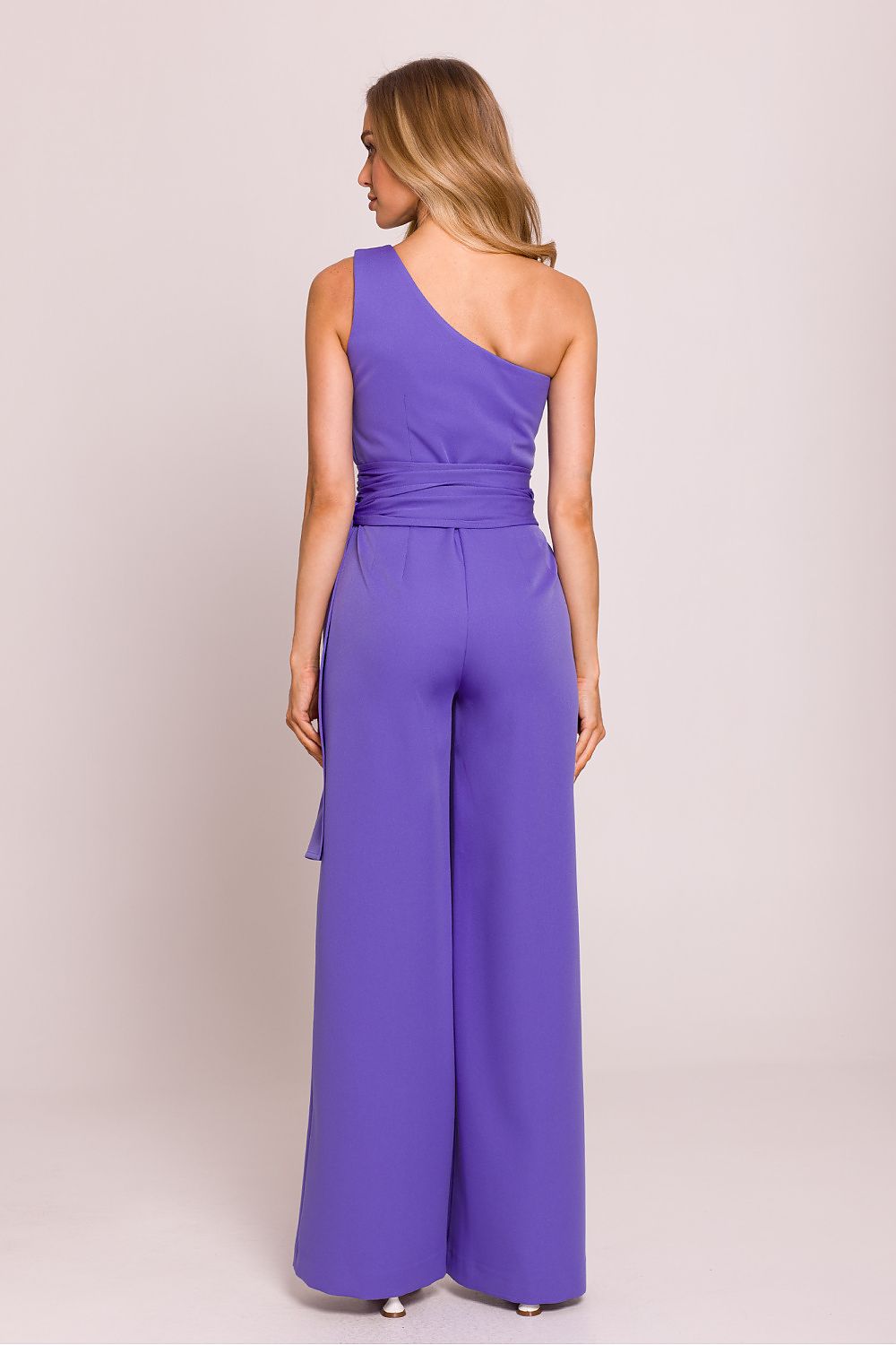 Elegant asymmetrical jumpsuit featuring unique shoulder motif, crafted by Moe, sizes S to XXL.