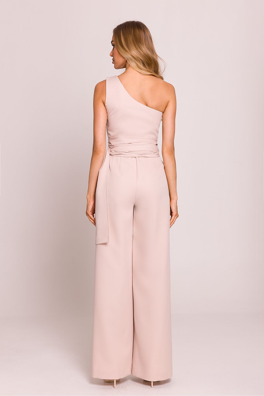 Close-up of the exquisite detail on the shoulder motif of the asymmetrical jumpsuit by Moe.