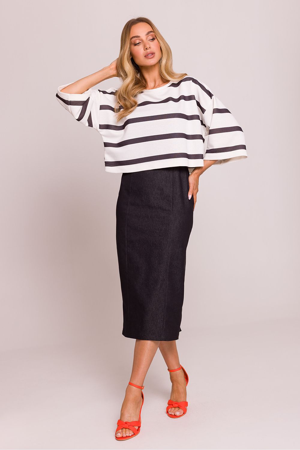 Fashionable Moe oversized striped knit sweater, styled with jeans for a sophisticated yet relaxed outfit, showcasing the boat neck design.