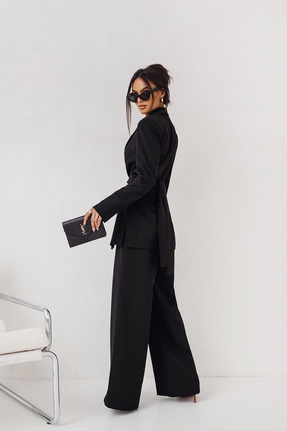 LaBalancia luxurious fuchsia women's suit ensemble laid out, featuring elegant trousers and jacket ideal for any sophisticated occasion.