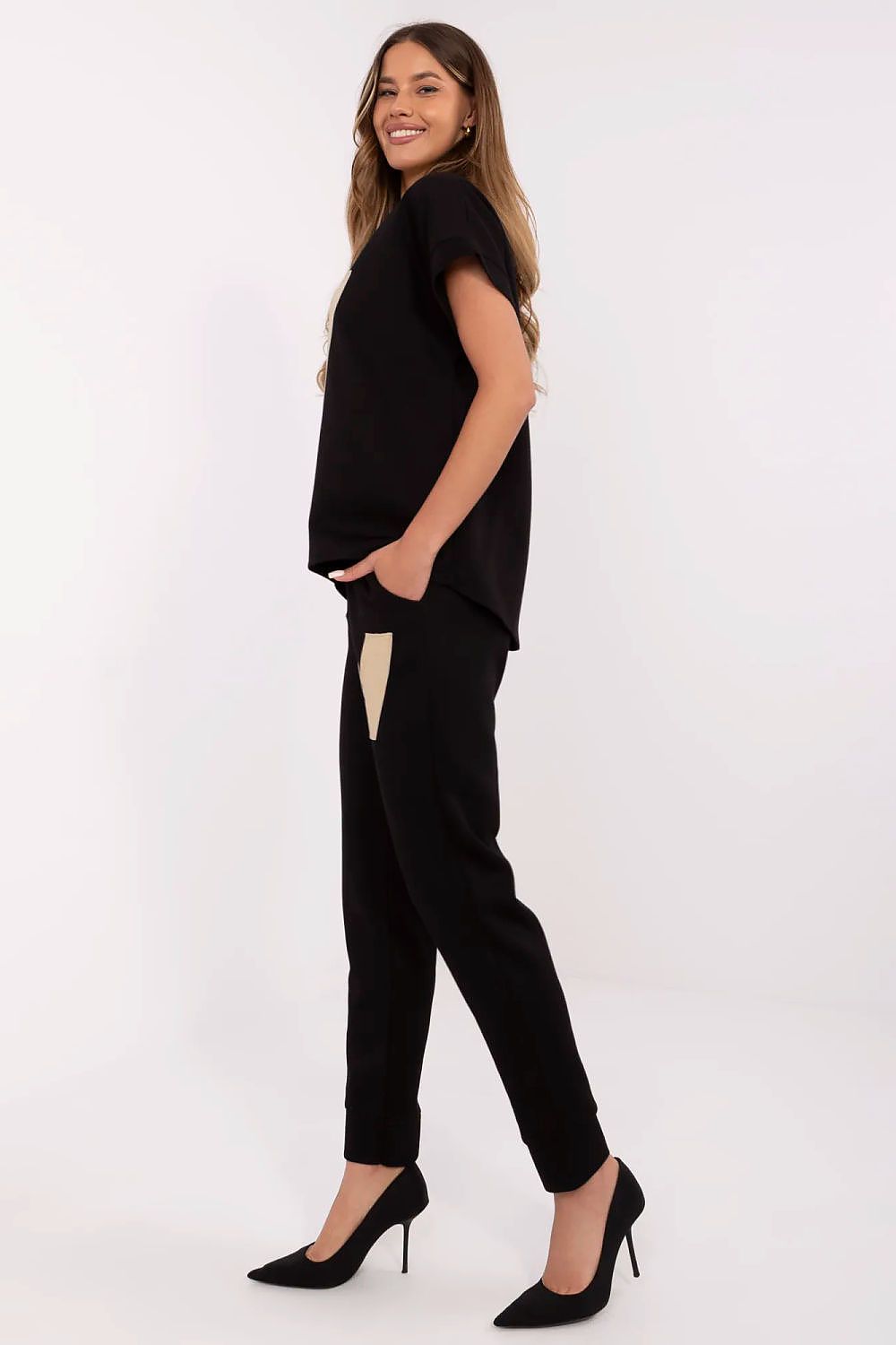 Close-up of Italy Moda's stylish women's comfort set showcasing the elegant detailing and luxurious fabric of the V-neck blouse paired with high-waisted pants.