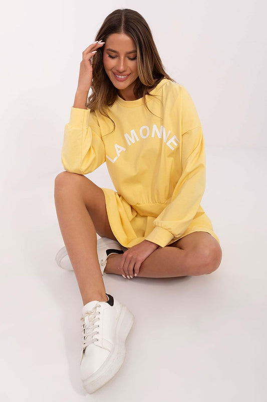 Luxurious Italy Moda sweatshirt featuring long sleeves and round neckline, perfect for sophisticated everyday wear paired with a pleated mini skirt.