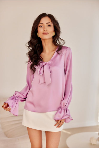 Elegant Roco Fashion blouse featuring long puffy sleeves and a decorative neck tie, perfect for sophisticated attire.