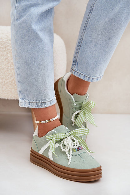 Charming detail of eco-suede platform sneakers featuring unique laces by Step in Style, designed to elevate everyday outfits.