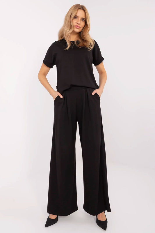 Elegant palazzo-style tracksuit trousers by Relevance in luxurious soft fabric, featuring a high waist and wide leg design for a sophisticated silhouette.