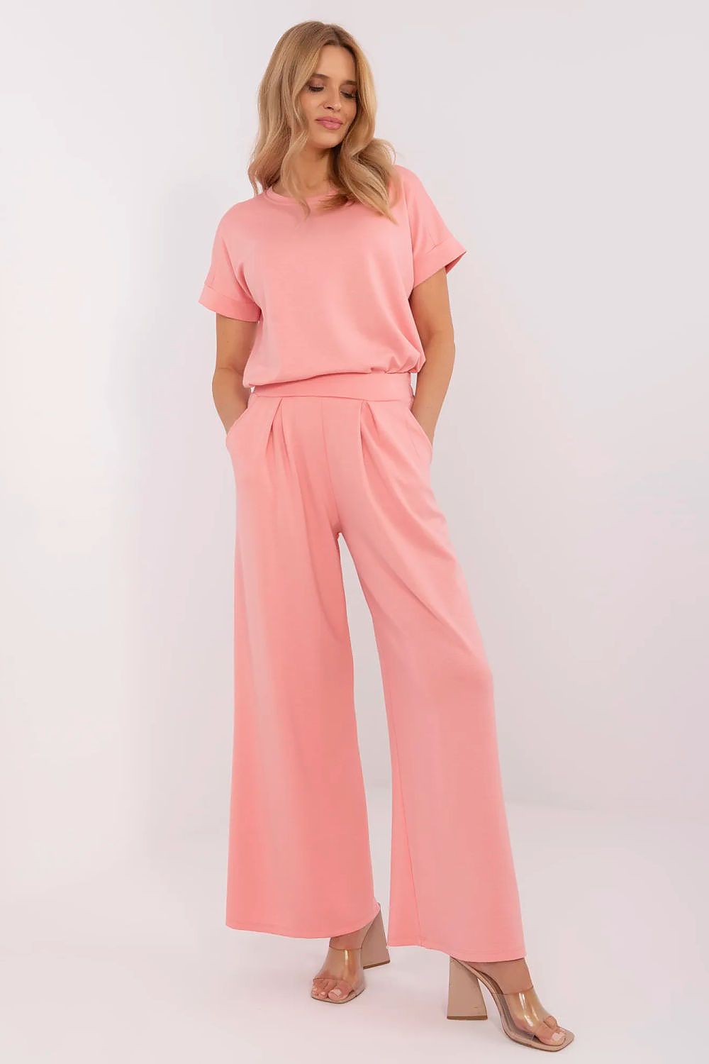 Stylish high waist palazzo trousers by Relevance featuring practical side pockets and decorative pleats for a sophisticated look.